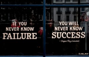 Image of a boxing gym window with quote by Sugar Ray Leonard saying "If you never know failure, you will never know success".